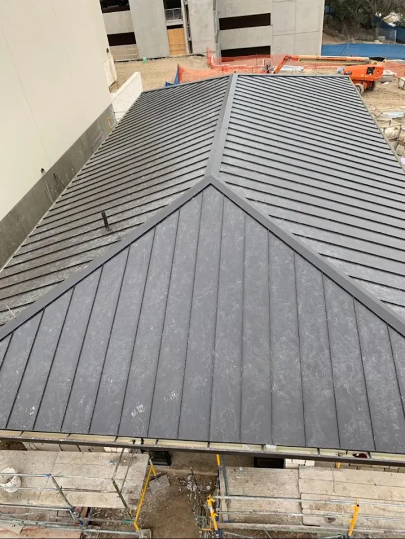 Commercial metal roof construction with crane equipment in Lake Barcroft