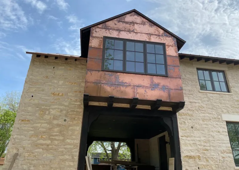 Copper metal panel facade on a stone building for Roof Repair in Lake Barcroft