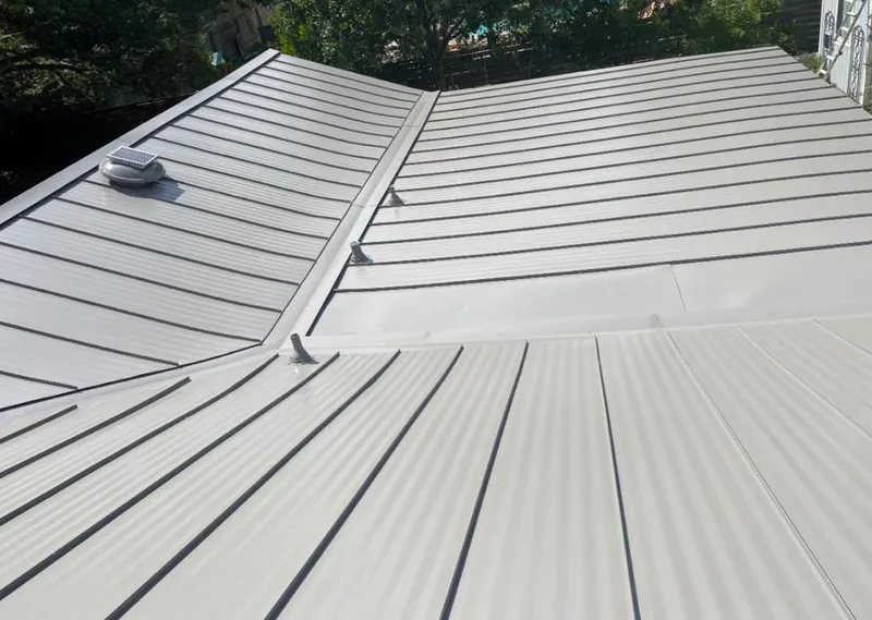 Solar attic fan installed on a metal roof for Roof Ventilation in Lake Barcroft